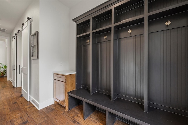 502 Vz County Road 1915, Fruitvale, TX 75127 - mudroom with a barn door, visible vents, dark wood finished floors, and baseboards