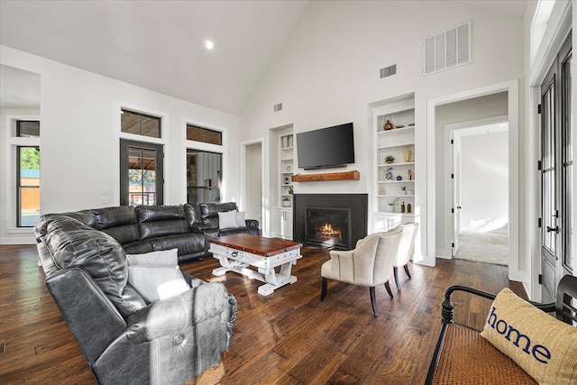 502 Vz County Road 1915, Fruitvale, TX 75127 - living area with visible vents, high vaulted ceiling, a lit fireplace, and built in features