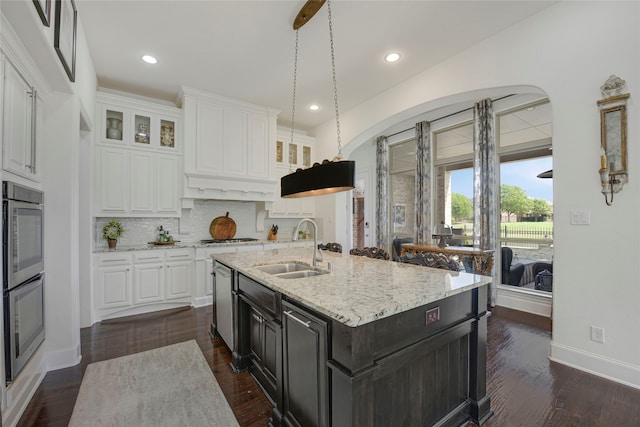 3429 Lochside, The Colony, TX 75056 - kitchen featuring tasteful backsplash, glass insert cabinets, stainless steel appliances, white cabinets, and a sink