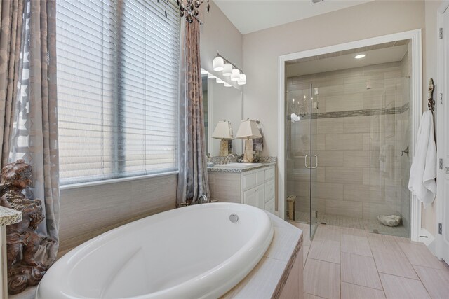3429 Lochside, The Colony, TX 75056 - bathroom featuring a bath, vanity, and a stall shower