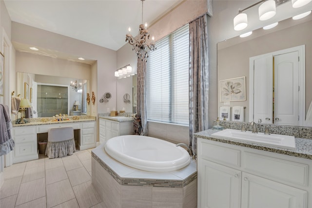 3429 Lochside, The Colony, TX 75056 - full bathroom featuring a stall shower, an inviting chandelier, a garden tub, and a sink