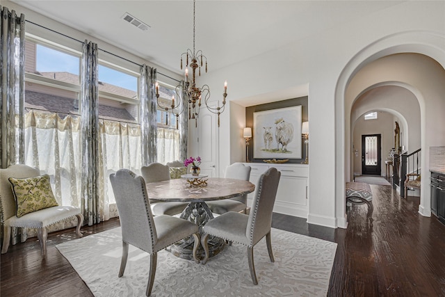 3429 Lochside, The Colony, TX 75056 - dining area featuring arched walkways, a chandelier, baseboards, visible vents, and dark wood-type flooring