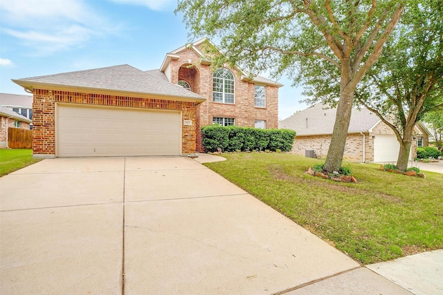 1415 Lowes Farm Pkwy, Mansfield, TX 76063 - traditional-style house featuring a front yard, an attached garage, brick siding, and concrete driveway