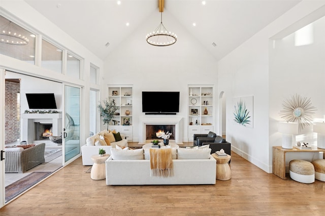 3110 High Rd, Flower Mound, TX 75022 - living area with a warm lit fireplace, high vaulted ceiling, light wood-type flooring, built in features, and baseboards