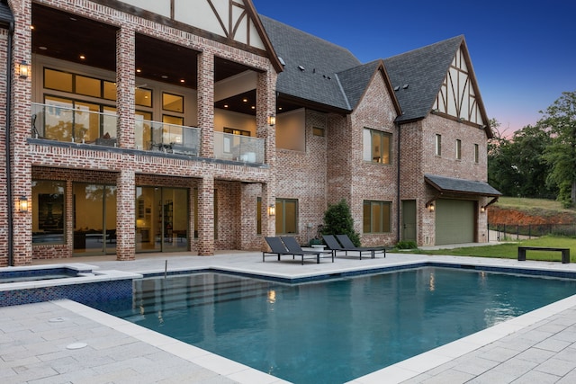 3110 High Rd, Flower Mound, TX 75022 - rear view of house featuring a balcony, a patio, brick siding, a pool with connected hot tub, and roof with shingles