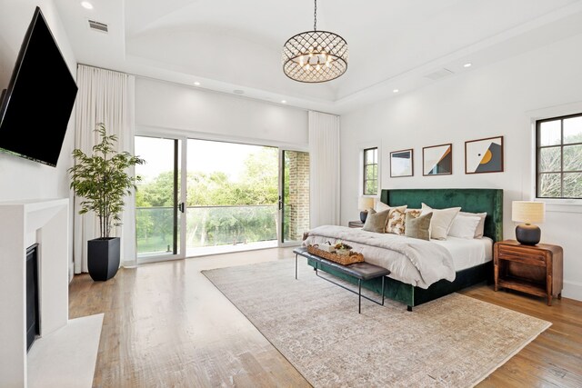 3110 High Rd, Flower Mound, TX 75022 - bedroom with access to outside, a chandelier, wood finished floors, a tray ceiling, and recessed lighting