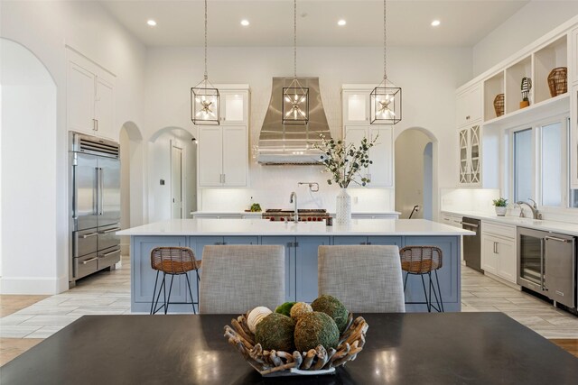 3110 High Rd, Flower Mound, TX 75022 - kitchen with stainless steel built in refrigerator, arched walkways, premium range hood, wine cooler, and recessed lighting