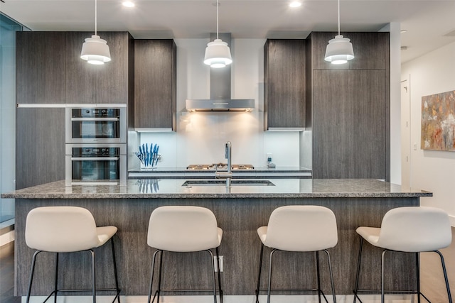 3130 N Harwood St Unit 901, Dallas, TX 75201 - kitchen featuring a sink, modern cabinets, extractor fan, and a breakfast bar