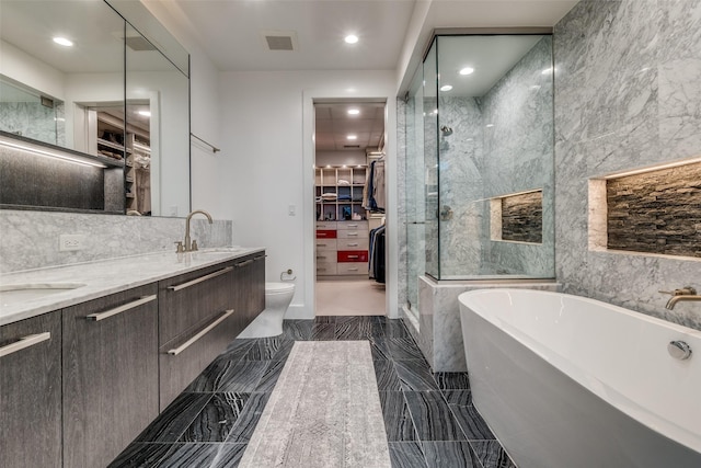 3130 N Harwood St Unit 901, Dallas, TX 75201 - full bath with visible vents, a freestanding tub, a shower stall, a sink, and a spacious closet