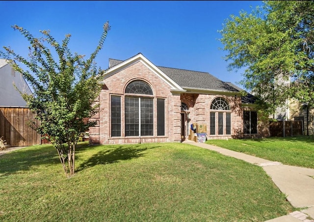 5517 Luna Dr, Rowlett, TX 75088 - view of front facade with brick siding, fence, and a front yard