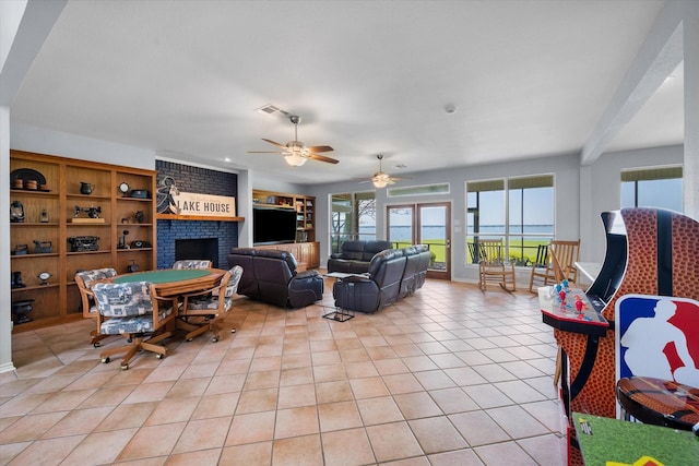 411 Pecan Point Dr, Kerens, TX 75144 - living area with light tile patterned floors, ceiling fan, and a brick fireplace