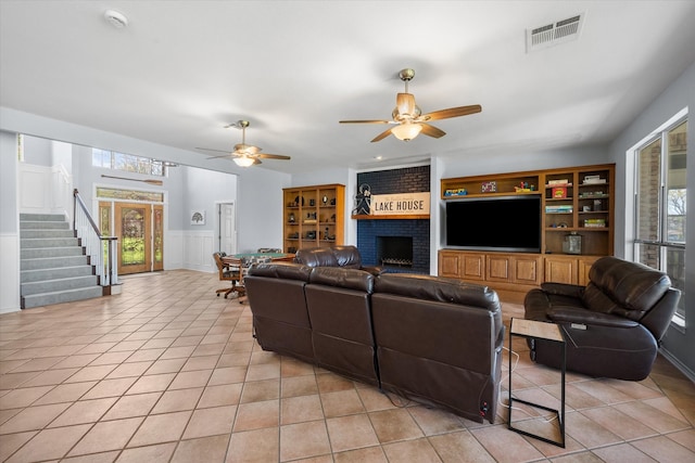 411 Pecan Point Dr, Kerens, TX 75144 - living area with visible vents, a fireplace, stairway, and ceiling fan