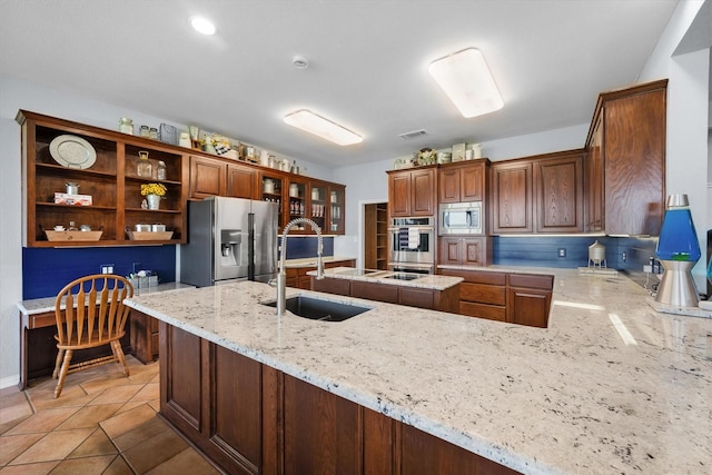 411 Pecan Point Dr, Kerens, TX 75144 - kitchen featuring visible vents, appliances with stainless steel finishes, light stone countertops, a sink, and a peninsula