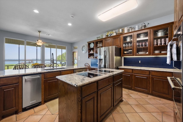 411 Pecan Point Dr, Kerens, TX 75144 - kitchen with a center island, recessed lighting, a sink, light tile patterned floors, and stainless steel appliances