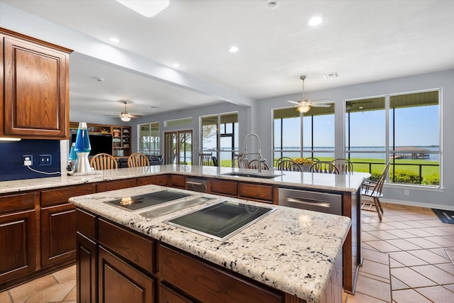 411 Pecan Point Dr, Kerens, TX 75144 - kitchen featuring a ceiling fan, black electric cooktop, a sink, and a center island