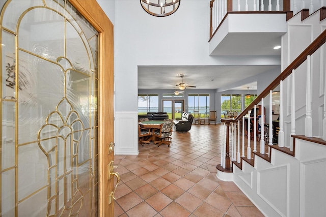 411 Pecan Point Dr, Kerens, TX 75144 - entrance foyer with a decorative wall, ceiling fan, stairway, and a wainscoted wall
