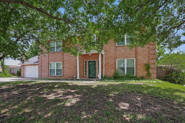 10313 Gray Oak Ln, Fort Worth, TX 76108 - colonial house featuring fence, an attached garage, driveway, and brick siding