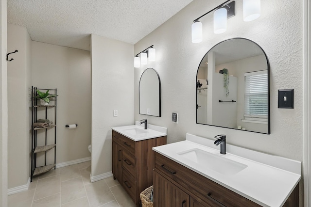 10313 Gray Oak Ln, Fort Worth, TX 76108 - bathroom featuring a sink, tile patterned flooring, a textured ceiling, and two vanities