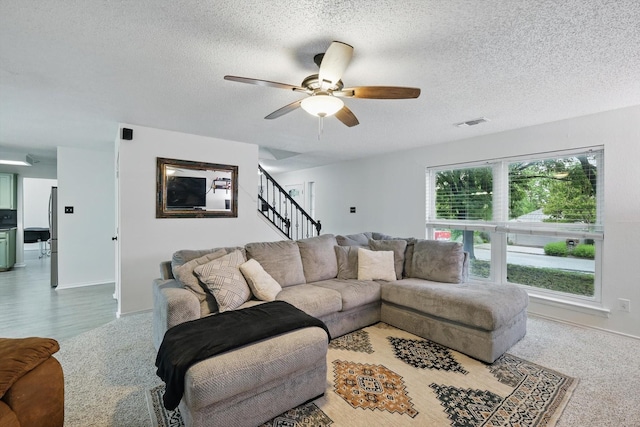 10313 Gray Oak Ln, Fort Worth, TX 76108 - carpeted living area featuring stairway, baseboards, ceiling fan, and a textured ceiling
