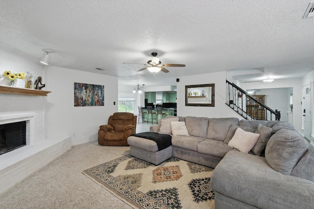 10313 Gray Oak Ln, Fort Worth, TX 76108 - carpeted living area with ceiling fan, a textured ceiling, visible vents, a fireplace, and stairway