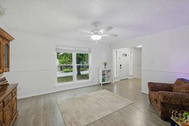10313 Gray Oak Ln, Fort Worth, TX 76108 - living room with a textured ceiling, ceiling fan, and light wood finished floors