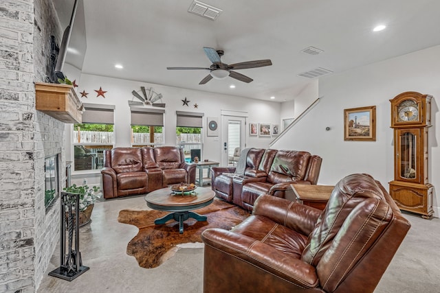 living room featuring a brick fireplace, recessed lighting, a ceiling fan, and visible vents