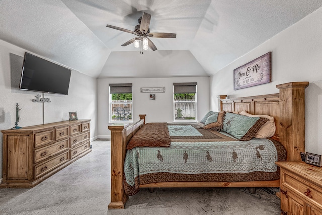 bedroom featuring a ceiling fan, a textured ceiling, lofted ceiling, and light colored carpet