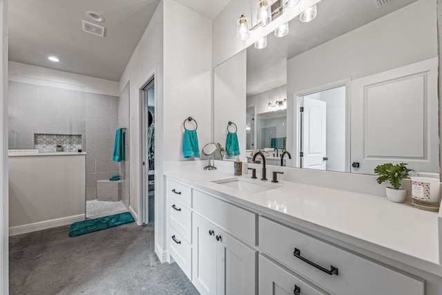 bathroom with visible vents, a walk in shower, recessed lighting, and vanity