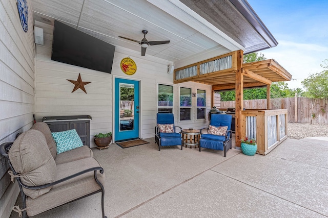 view of patio with fence and a ceiling fan