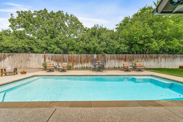 view of swimming pool featuring a patio, a fenced in pool, and a fenced backyard