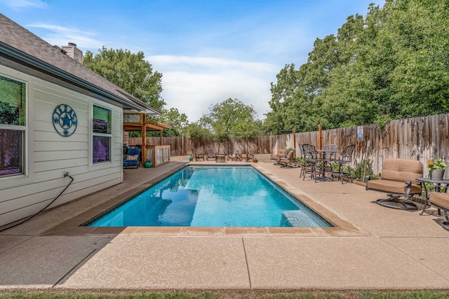 view of swimming pool featuring a patio, a fenced in pool, and a fenced backyard