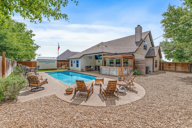 view of pool featuring a fenced backyard, a fenced in pool, and a patio area