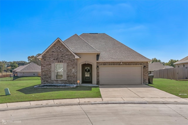 3843 Joseph Randall Dr, Shreveport, LA 71107 - view of front of home with brick siding, fence, driveway, a front yard, and an attached garage