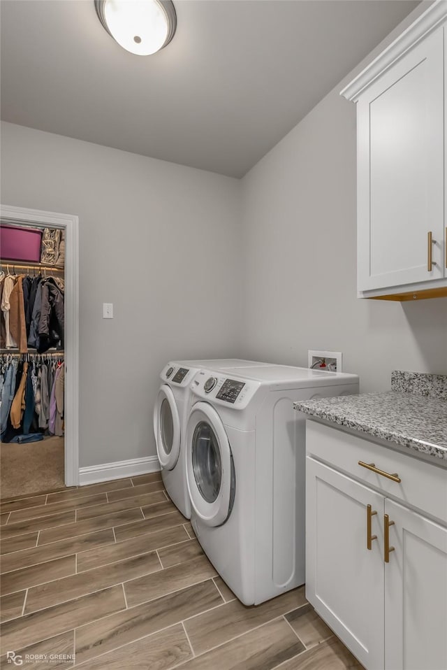 3843 Joseph Randall Dr, Shreveport, LA 71107 - clothes washing area with baseboards, wood finish floors, cabinet space, and washer and clothes dryer