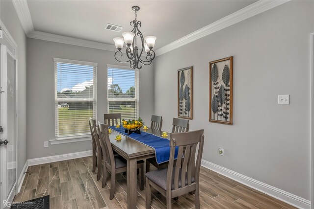 3843 Joseph Randall Dr, Shreveport, LA 71107 - dining space featuring ornamental molding, wood finish floors, a notable chandelier, and baseboards