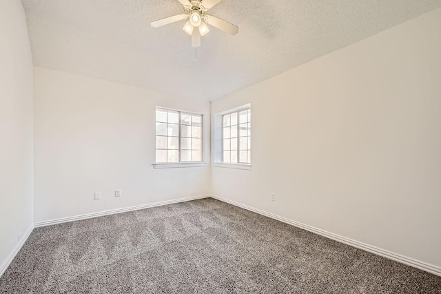 unfurnished room with baseboards, dark colored carpet, a ceiling fan, and a textured ceiling