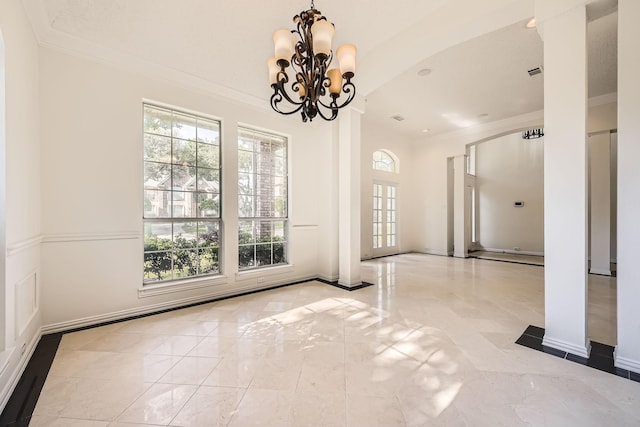 unfurnished dining area with baseboards, an inviting chandelier, crown molding, and marble finish floor