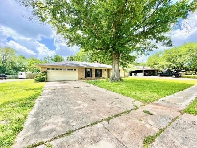 single story home with driveway, a front lawn, and an attached garage