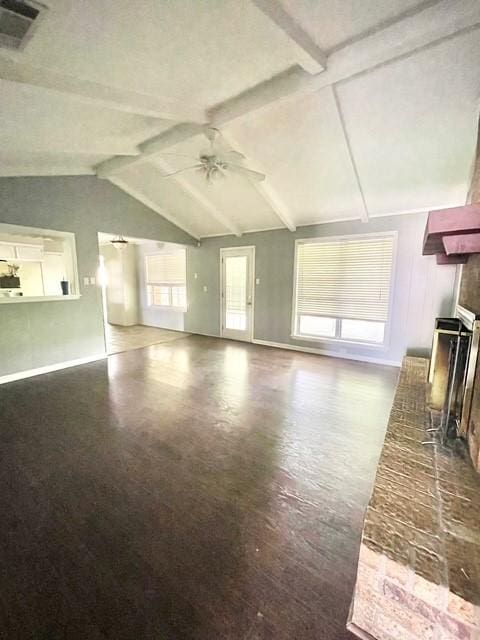 unfurnished living room with visible vents, baseboards, a brick fireplace, a ceiling fan, and vaulted ceiling with beams