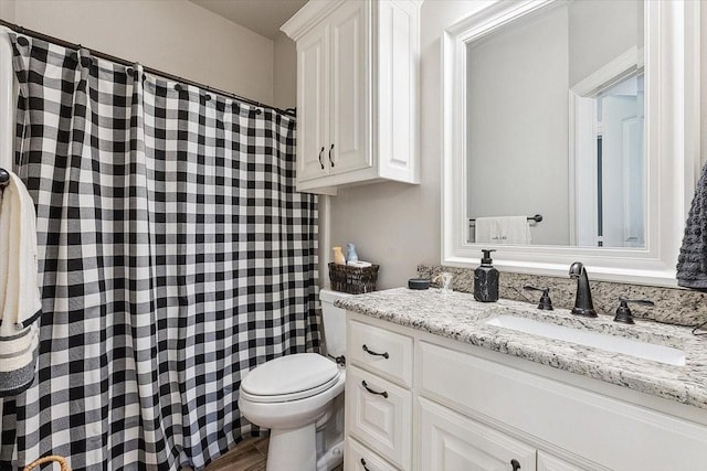 full bathroom with vanity, toilet, and curtained shower