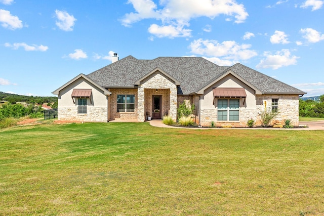 150 Cherokee Hills Ln, Abilene, TX 79606 - view of front of home with a front lawn, stone siding, and roof with shingles