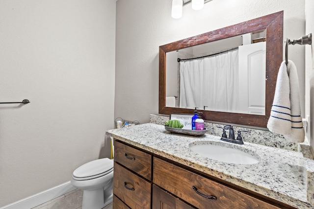 150 Cherokee Hills Ln, Abilene, TX 79606 - full bath featuring vanity, toilet, a textured wall, baseboards, and tile patterned flooring