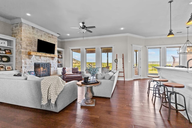 150 Cherokee Hills Ln, Abilene, TX 79606 - living room with a fireplace, dark wood-type flooring, a healthy amount of sunlight, and a ceiling fan