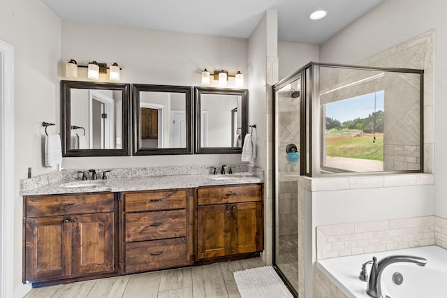 150 Cherokee Hills Ln, Abilene, TX 79606 - bathroom featuring a stall shower, double vanity, a sink, and a bath