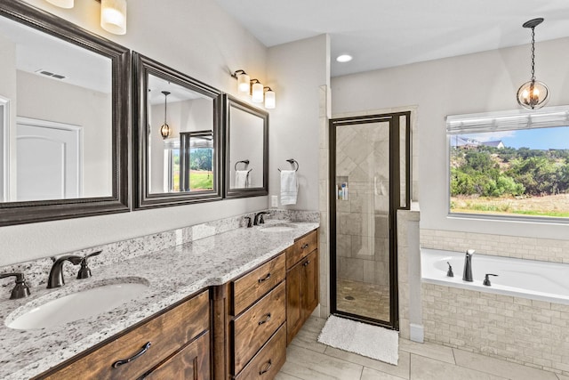 150 Cherokee Hills Ln, Abilene, TX 79606 - bathroom with a sink, a shower stall, a bath, tile patterned floors, and visible vents
