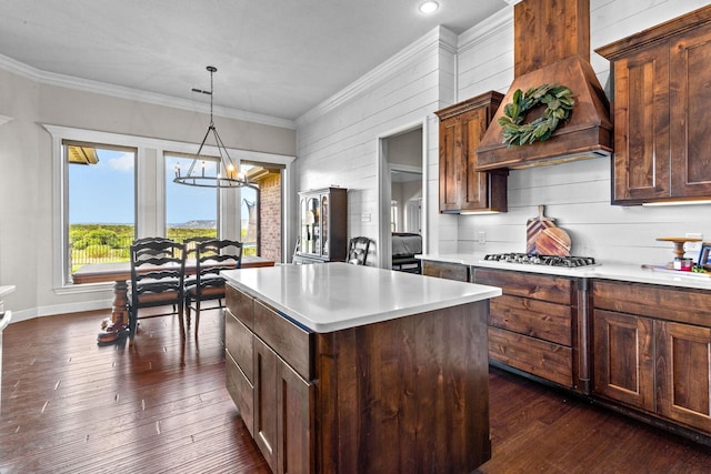 150 Cherokee Hills Ln, Abilene, TX 79606 - kitchen featuring light countertops, a center island, stainless steel gas cooktop, custom exhaust hood, and a notable chandelier
