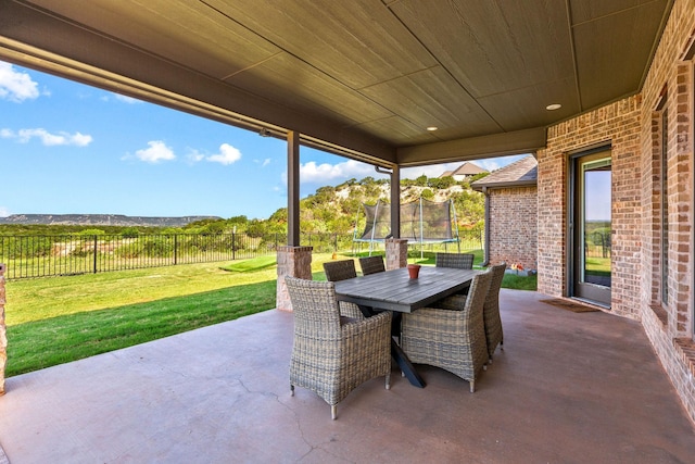 150 Cherokee Hills Ln, Abilene, TX 79606 - view of patio / terrace featuring a trampoline, outdoor dining space, and a fenced backyard