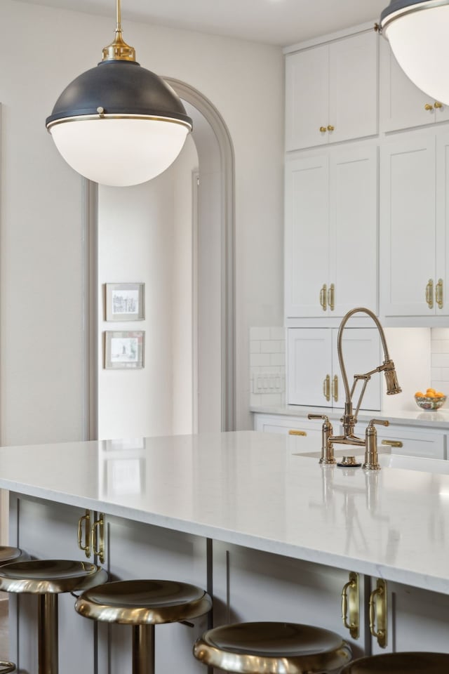 14000 Walsh Ave, Fort Worth, TX 76008 - kitchen with a breakfast bar, white cabinetry, and decorative backsplash