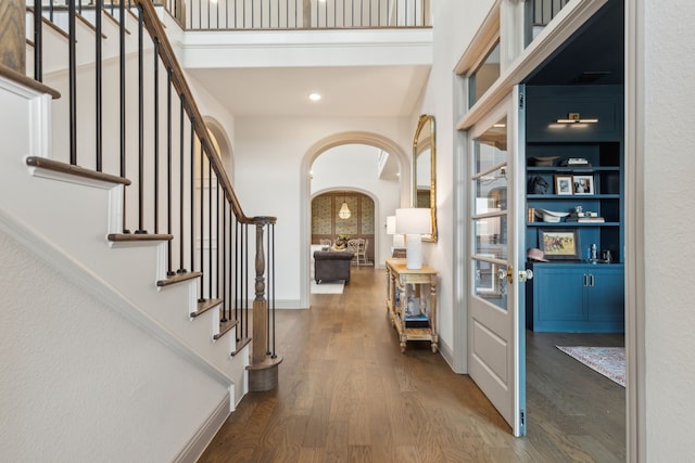14000 Walsh Ave, Fort Worth, TX 76008 - entrance foyer with arched walkways, wood finished floors, stairs, a high ceiling, and baseboards