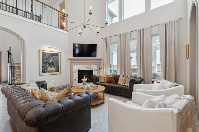 14000 Walsh Ave, Fort Worth, TX 76008 - living area with a towering ceiling, a chandelier, a premium fireplace, and baseboards